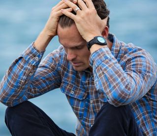 Man in Blue and Brown Plaid Dress Shirt Touching His Hair